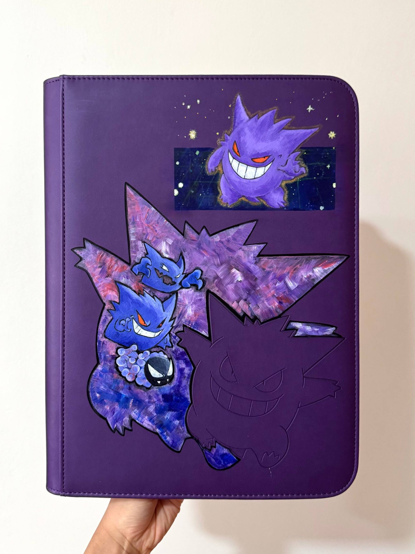 Gengar evolution line — Gastly, Haunter and Gengar — hand painted on a purple binder