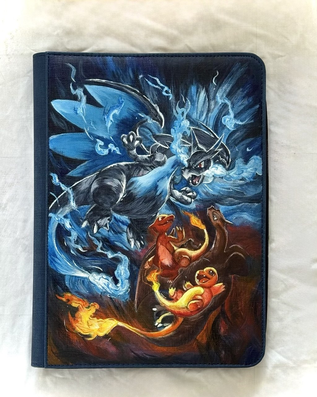 Mega Charizard X and Y battle scene with the Charmander evolution line, hand painted on a binder